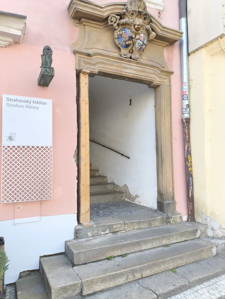 The passage beside Café Melvin, with the Strahov Abbey sign on the left.